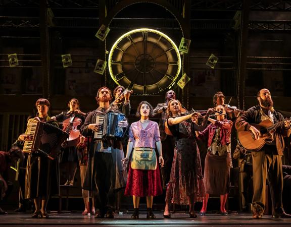 Actors perform Amélie the Musical live on stage.
