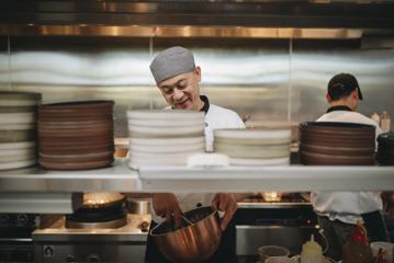 A chef working in the kitchen at Hei Chinese restaurant.