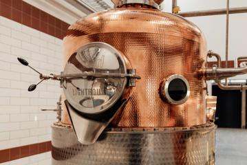 A large copper vat at The Runholder, a restaurant, tasting room, cellar door, distillery, and barrel hall space in Martinborough.