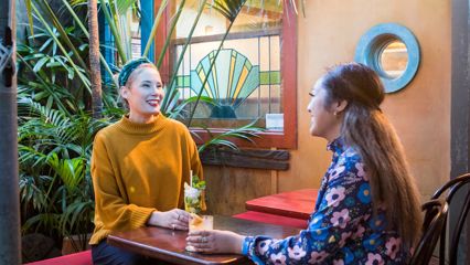 Two friends enjoy cocktails at Havana Bar.