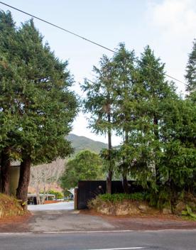 Camp Wainuiomata screen location. Has several buildings and is surrounded by forest and bush.