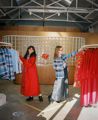 Two people holding colourful outfits at the twenty-seven names fashion store in Wellington