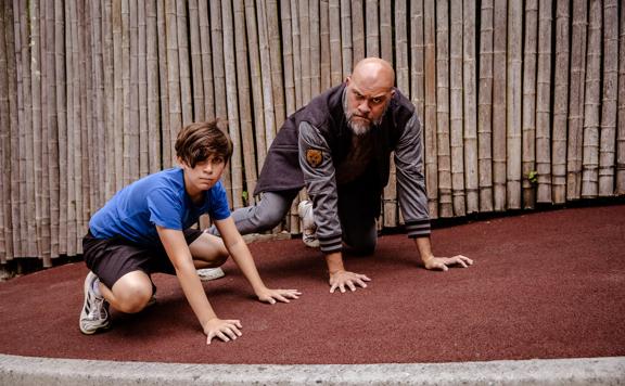 Wellingtonian Allan Henry, who plays the bear in ‘Cocaine Bear’, with his child pretending to be bears on the ground at Wellington Zoo.