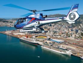 A helicopter flying over the Wellington Harbour with the city centre visible in the background.