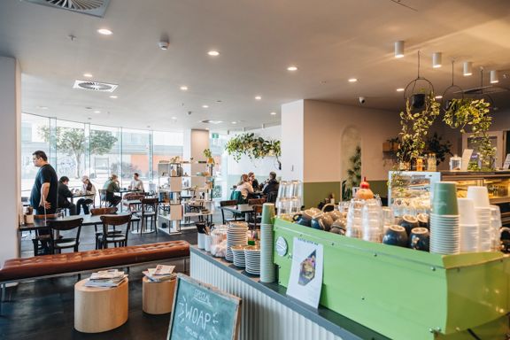 Kākāriki Coffee interior showing coffee machine and cafe tables