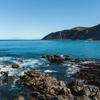 The bright blue water and rugged coastline at Red Rocks on Wellington's south coast.