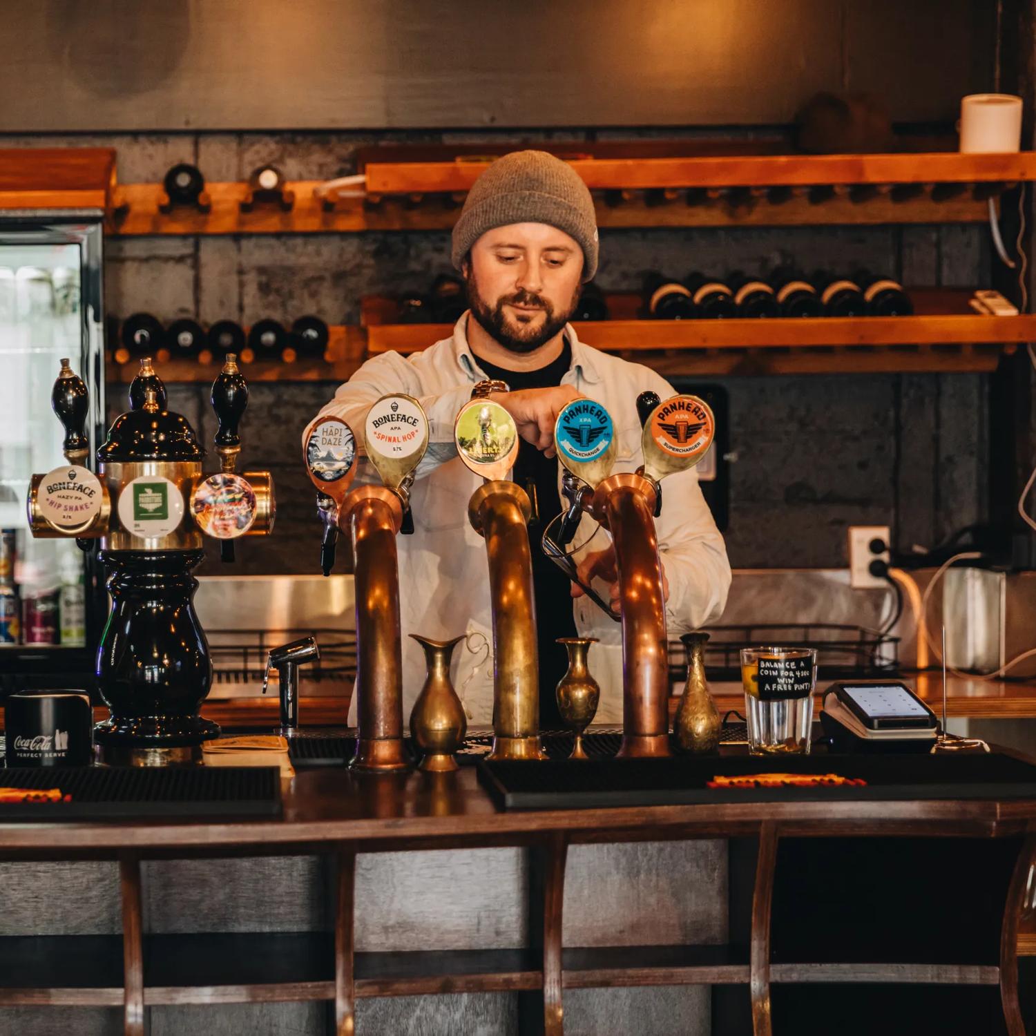 A bartender pours a pint of beer at 187 Bar.