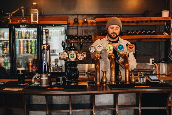A bartender pours a pint of beer at 187 Bar.