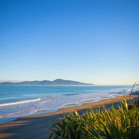 The beach at Queen Elizabeth Regional Park in the Kāpiti Coast with a view of Kapiti Island.