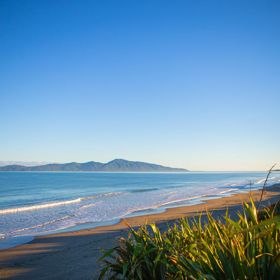 The beach at Queen Elizabeth Regional Park in the Kāpiti Coast with a view of Kapiti Island.