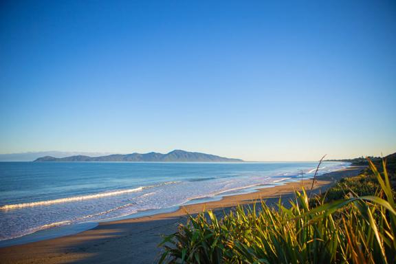 The beach at Queen Elizabeth Regional Park in the Kāpiti Coast with a view of Kapiti Island.