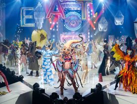 Various designs entered in the Crazy Curiosities of the Creature Carnival section in the World of WearableArt Show 2024 line the stage.