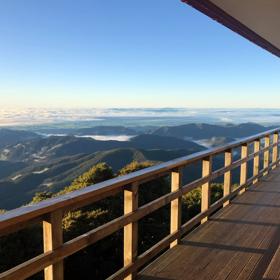 The view of mountain ranges from a wooden deck.