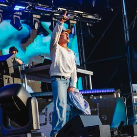 A performer on stage at an outdoor concert.