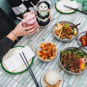 A table at Mr. Go's with dishes and drinks.