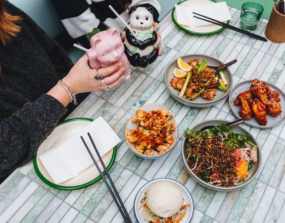 A table at Mr. Go's with dishes and drinks.