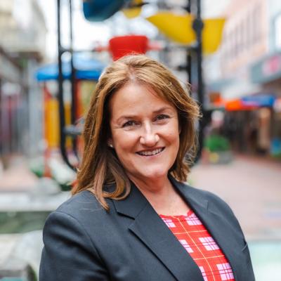 Headshot of Jo Healey,  board member of WellingtonNZ, smiling in front of the Bucket Fountain.