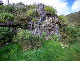 The screen location of Remutaka Summit, wit views of surrounding peaks, lush green bush and steep roads cut into the sides of the mountains.