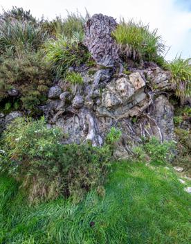 The screen location of Remutaka Summit, wit views of surrounding peaks, lush green bush and steep roads cut into the sides of the mountains.