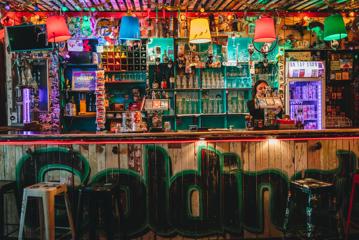 A bartender pours a pint behind the bar at Golding's Free Dive, an eclectic bar in Te Aro, Wellington.