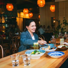 Two friends enjoy a meal and drinks at Apachè.