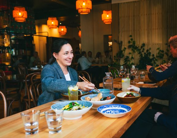 Two friends enjoy a meal and drinks at Apachè.