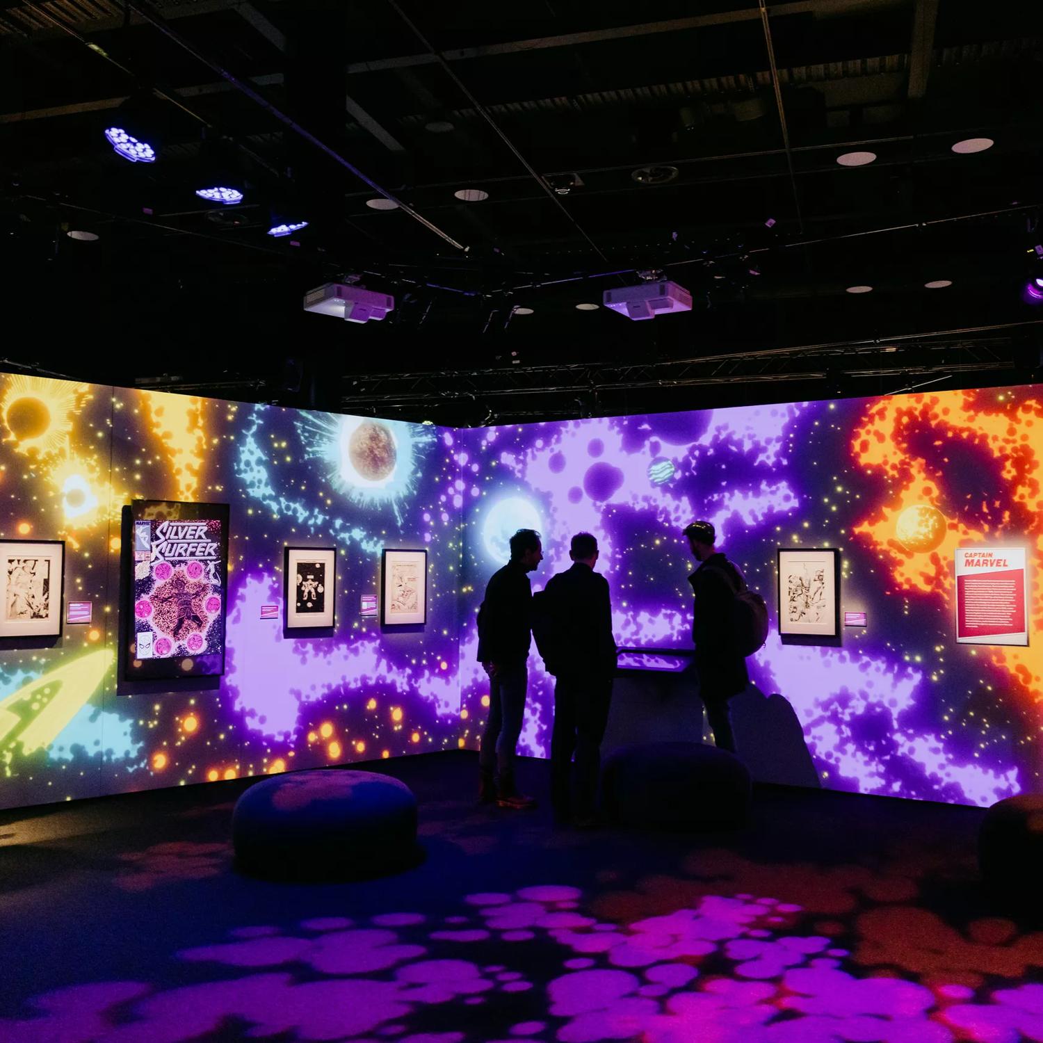 Marvel: Earth's Mightiest Exhibition at Tākina Convention Centre in Wellington. Three people are looking at a display.