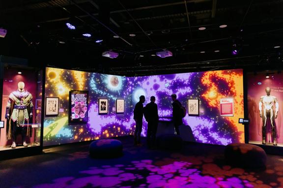 Marvel: Earth's Mightiest Exhibition at Tākina Convention Centre in Wellington. Three people are looking at a display.