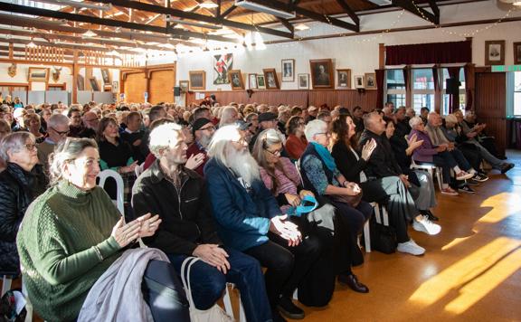 An audience applauds at an event at Featherston Booktown.