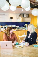 Prologic Skincare Founder Rachel Robertson, and her mentor, Pieta Reid, sit and chat in a café.