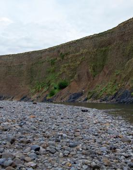 The screen location of Te Mārua  cliffs, where a river flows against vertical cliffs on the foothills of the Remutaka Range.