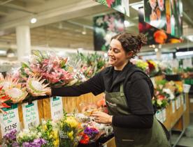 A worker reached for a bouquet in the flower section of Moore Wilson's.