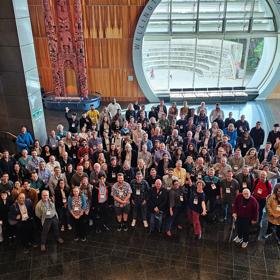 Around 100 people looking up at the camera at the Interntaional Crustacean Congress at Te Papa in May 2023.