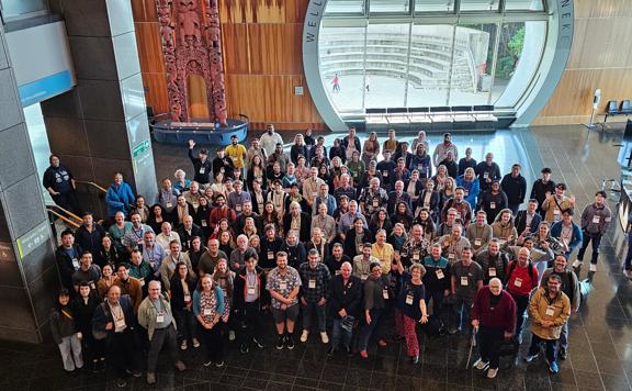 Around 100 people looking up at the camera at the Interntaional Crustacean Congress at Te Papa in May 2023.