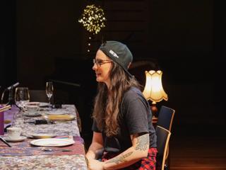 Casey Zilbert sits at a table wearing a backwards black cap and black teeshirt.