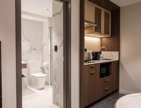 A kitchenette and marble bathroom pictured at The Sebel, Lower Hutt.