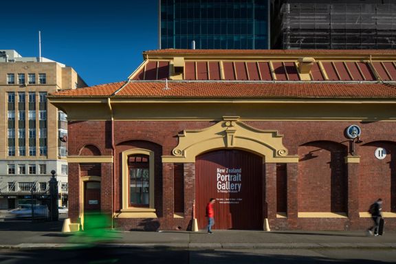 Exterior of the New Zealand Portrait Gallery in Wellington, housed in the historic brick Shed 11 building on the waterfront.