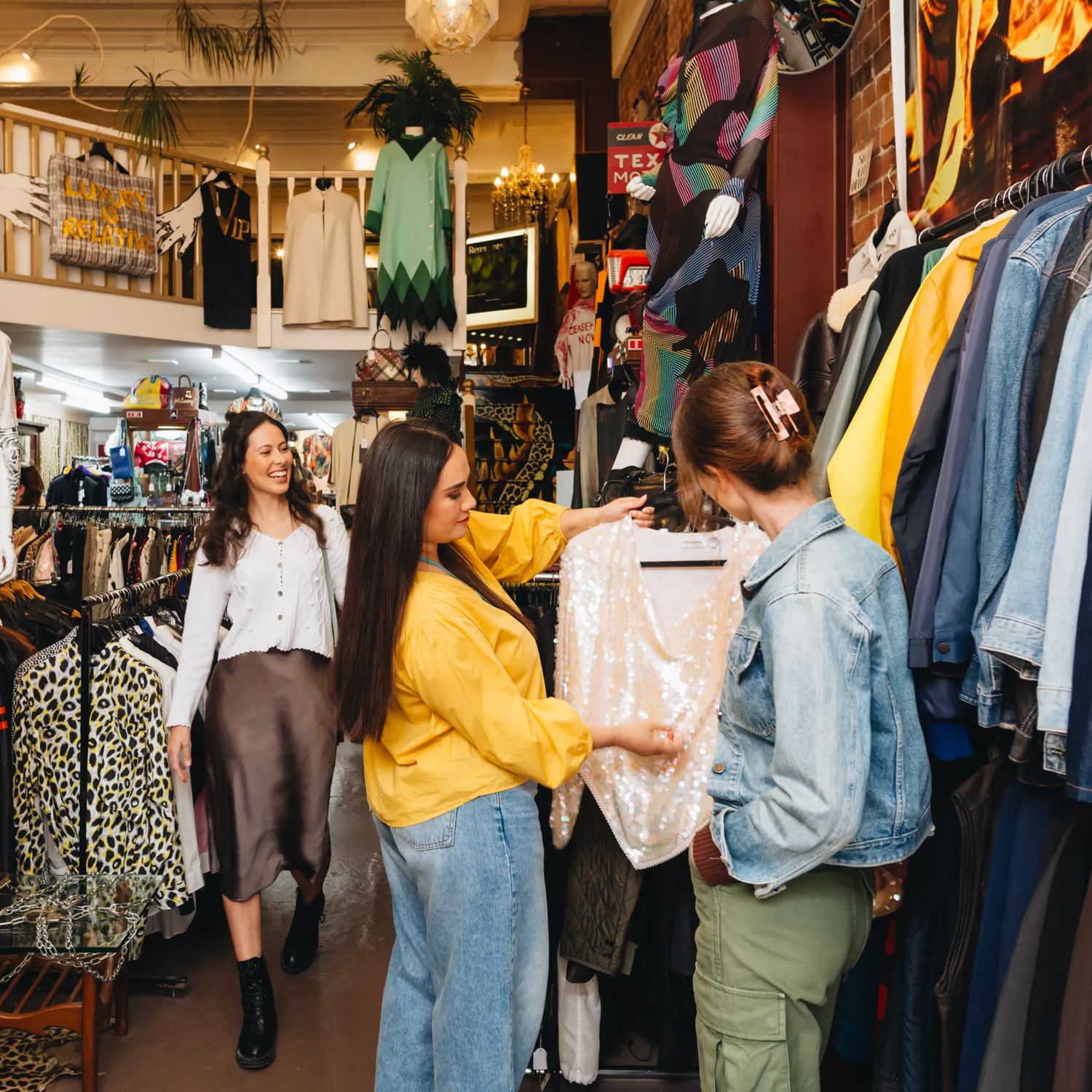 People browsing and shopping among racks of vintage clothing at Hunters & Collectors in Wellington.