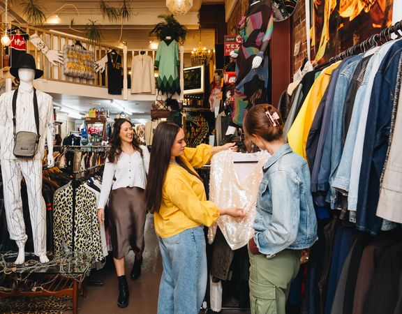 People browsing and shopping among racks of vintage clothing at Hunters & Collectors in Wellington.