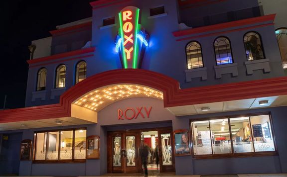 The exterior facade of Roxy Cinema at night in Wellington.