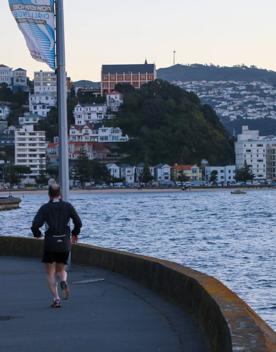 The screen location of Oriental Bay, wth pastel-coloured, Art Deco apartments, brightly-painted boat sheds, and the golden beach.