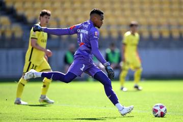 The Wellington Phoenix FC goalie winds up to kick the ball down the field.