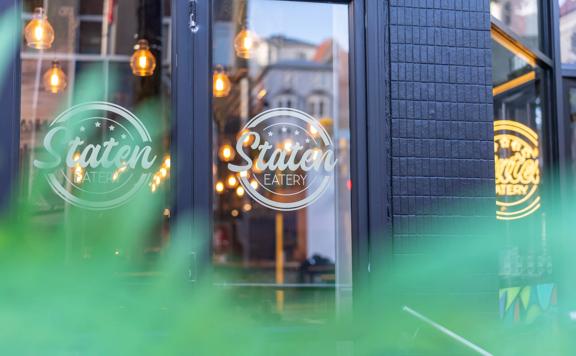 Looking into the glass windows of Staten eatery, on the ground floor of Mercure Abel tasman Hotel.