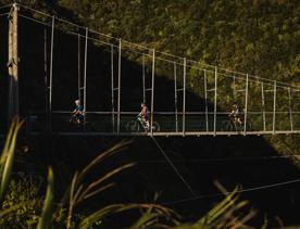 3 bikers on the 'Upswing' Track on Mākara Peak Mountian Bike Park.