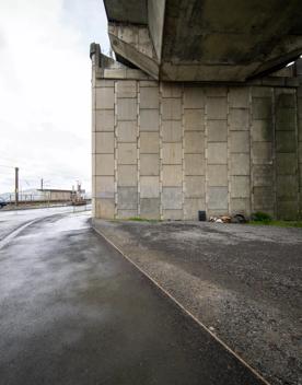 The urban setting of the Hutt Road Ngauranga Interchange, where highways got over tunnels with walls that once had graffiti.