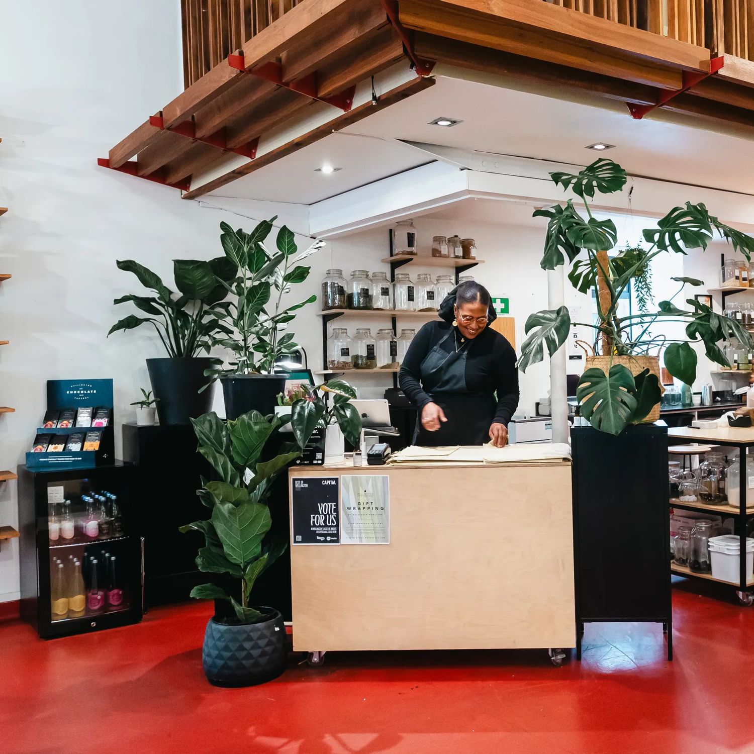 A worker stands behind the counter at Wellington Apothecary.