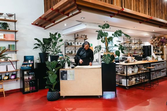 A worker stands behind the counter at Wellington Apothecary.