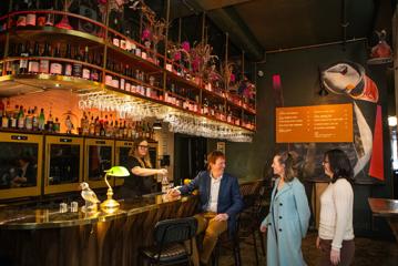 Three conference attendees meet for drinks at Puffin wine bar in Wellington.