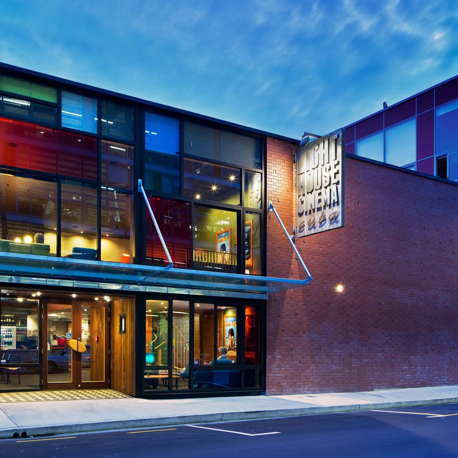 Exterior of Light House Cinema Cuba on Wigan Street in Wellington, featuring a modern glass-fronted entrance illuminated at dusk.