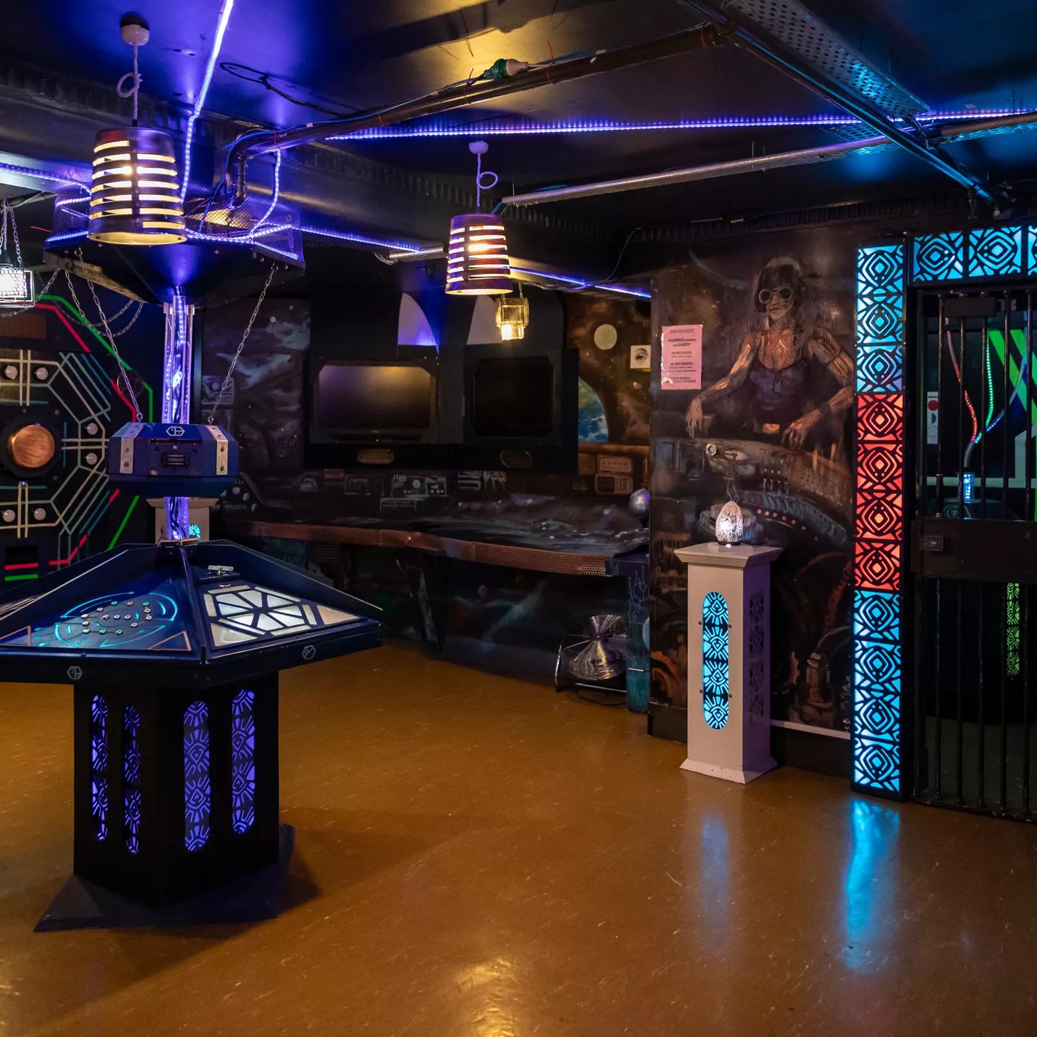 The interior of Escape Mate, an escape room located in Wellington Central. The room has colourful accent lighting and futuristic-space-themed decor. 